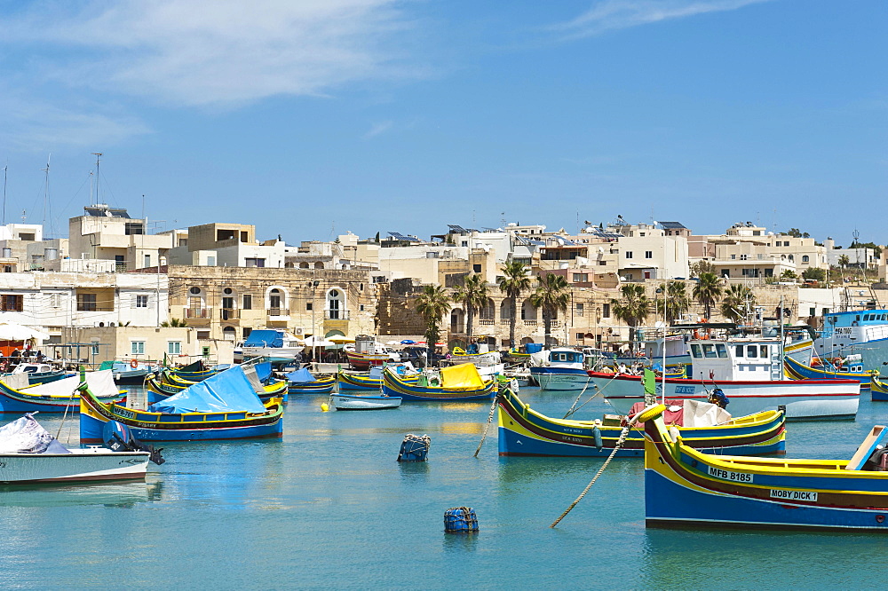 Colorfully painted traditional fishing boats, Luzzu, harbour of Marsaxlokk, Malta, Europe