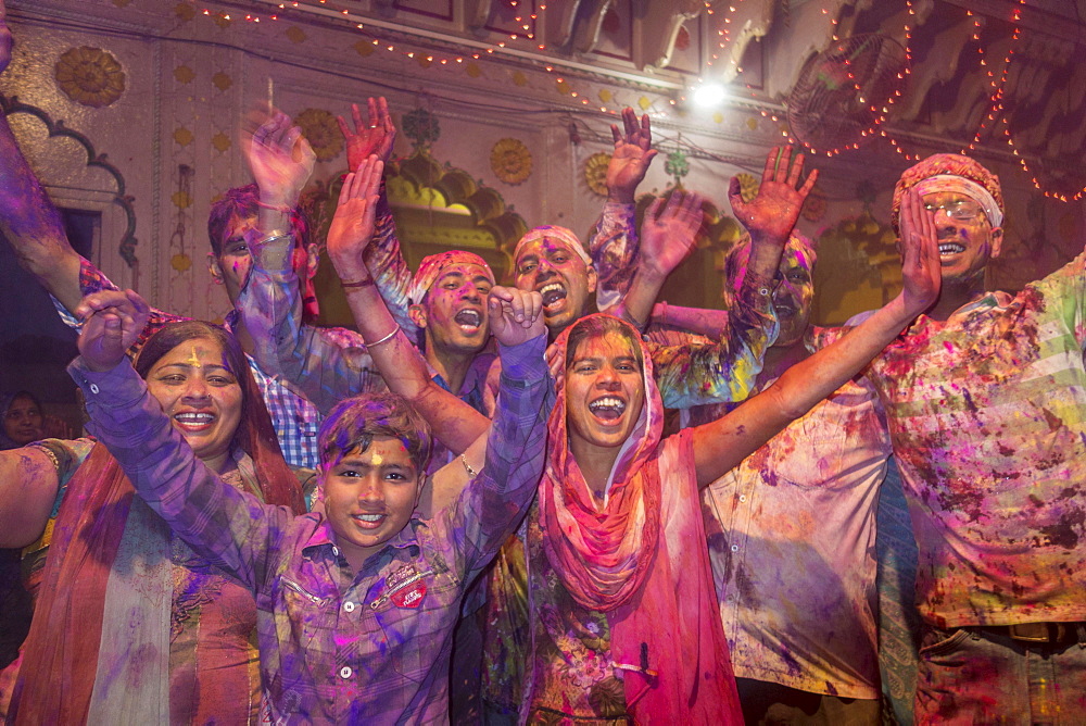 Devotees covered in coloured powder celebrating, Holi festival, Banke Bihari Temple, Vrindavan, Uttar Pradesh, India, Asia