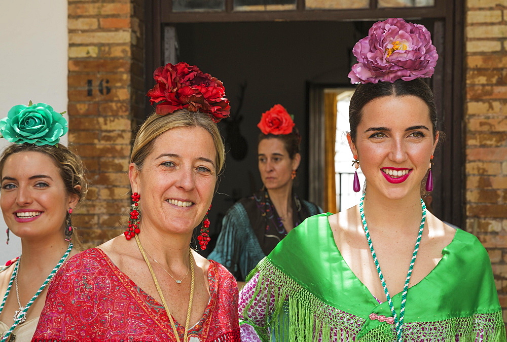 Women wearing colourful gypsy dresses, Pentecost pilgrimage of El Rocio, Huelva province, Andalusia, Spain, Europe