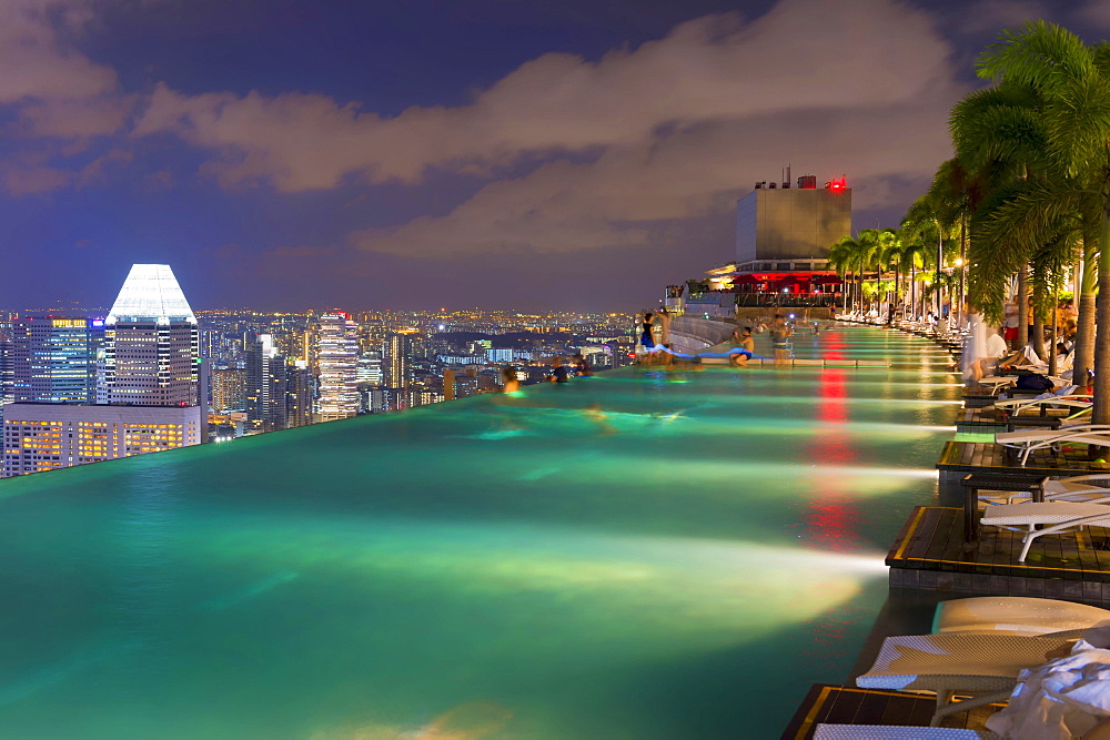 Downtown central financial district at night viewed from the Infinity pool of the Marina Bay Sands, Singapore, Asia