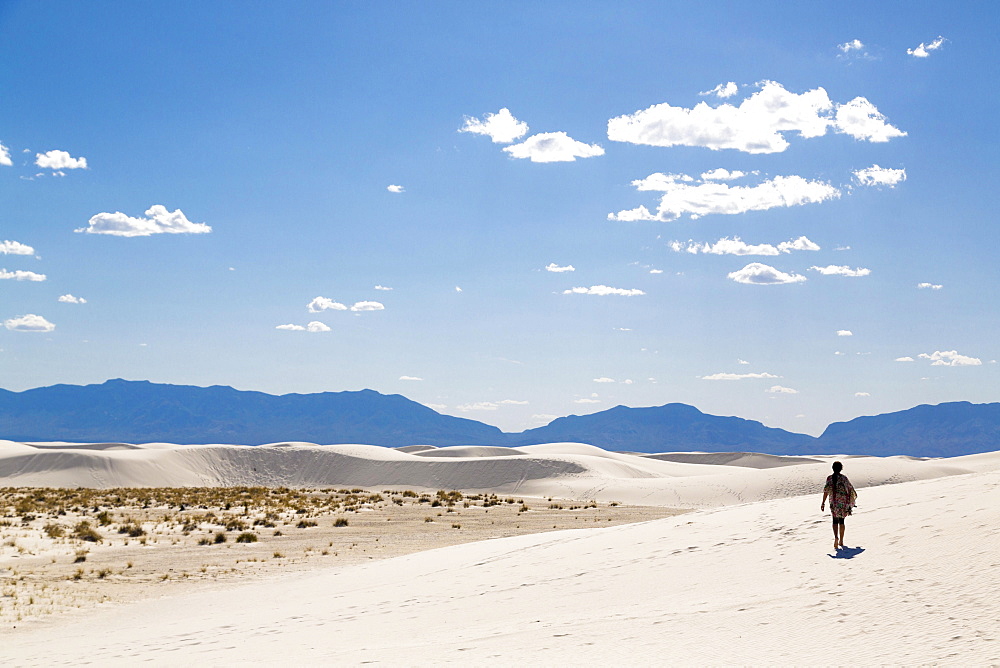 Sand dunes, person in the backlight, mountains behind, White Sands National Monument, Alamogordo, New Mexico, USA, North America