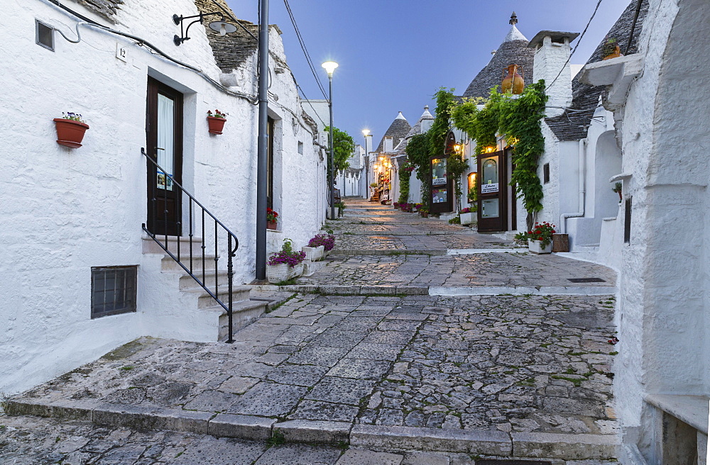 Dusk, shop, trulli traditional round houses, Rione Monti, Alberobello, Valle d'Itria, Trulli Valley, Apulia, Italy, Europe