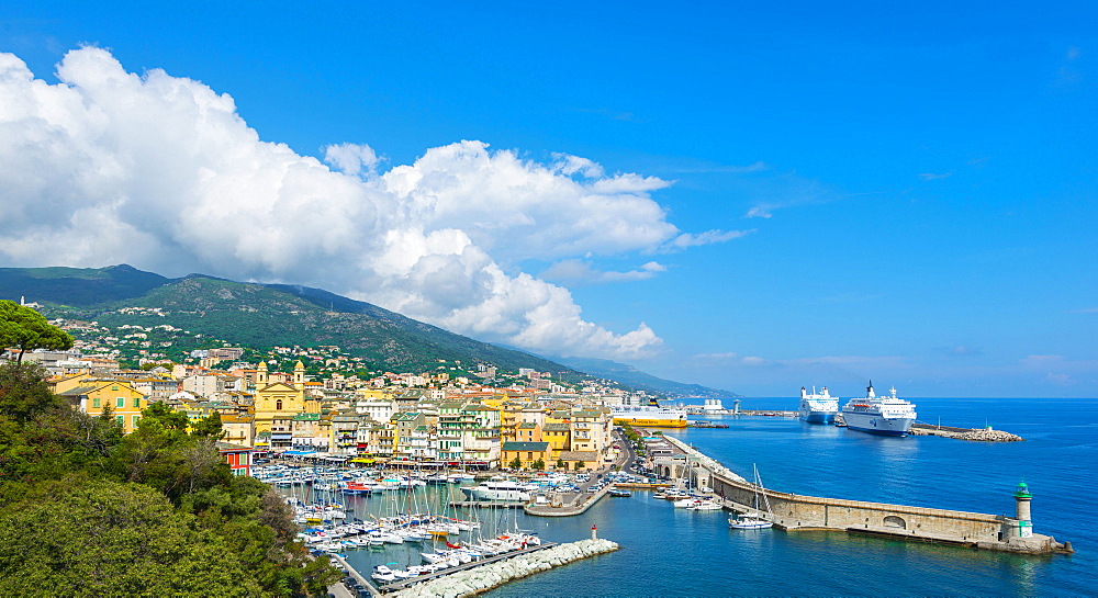 Overview of the old town, the old harbor and the new ferry terminal with the church of Saint-Jean-Baptiste, Bastia, Corsica, France, Europe