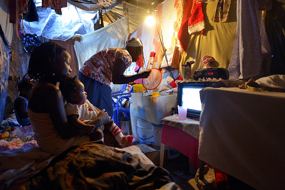 Woman and children in a ramshackle hut, Camp Icare, camp for earthquake refugees, Fort National, Port-au-Prince, Haiti, Central America