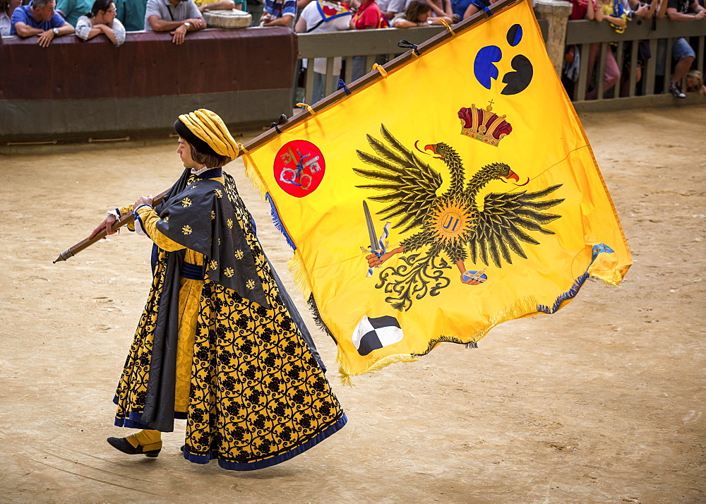 Man carrying a flag from the Eagle or Aquila contrade, historical parade before the Palio di Siena horse race, Siena, Tuscany, Italy, Europe