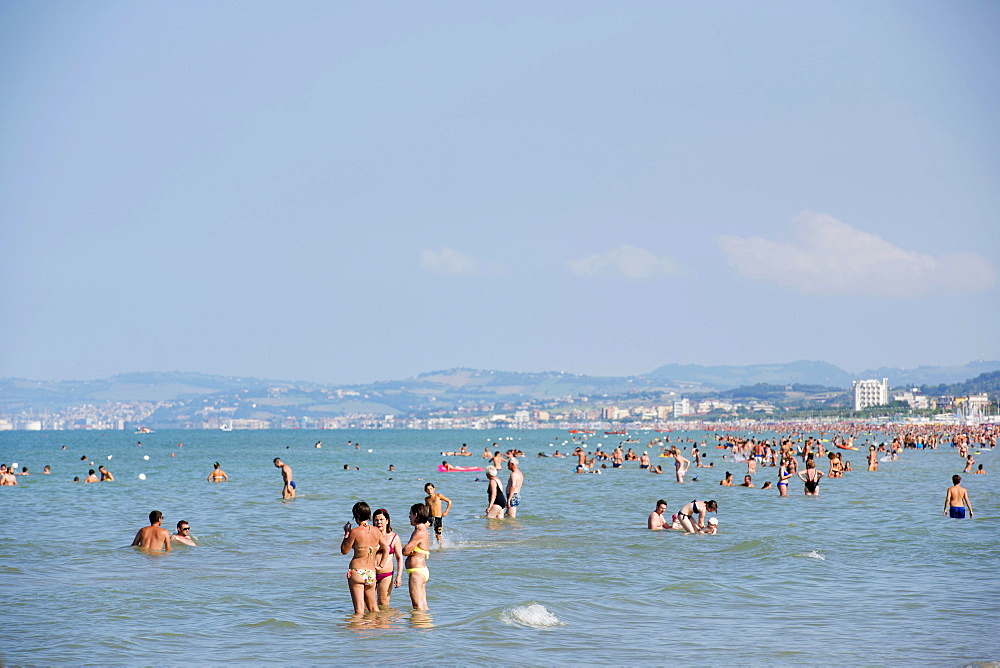 Tourists bathing in the sea, town of Ancona at the back, Senigallia, Province of Ancona, Marche, Italy, Europe