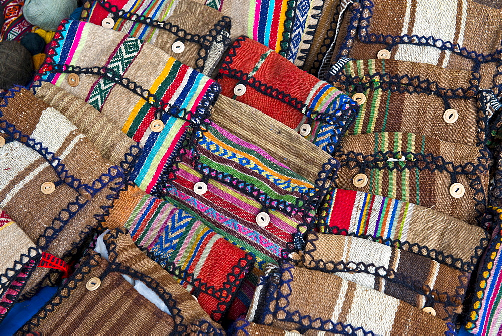 Handmade bags with the traditional patterns of the Quechua Indians are displayed for sale, Cinchero, Urubamba Valley, Peru, South America