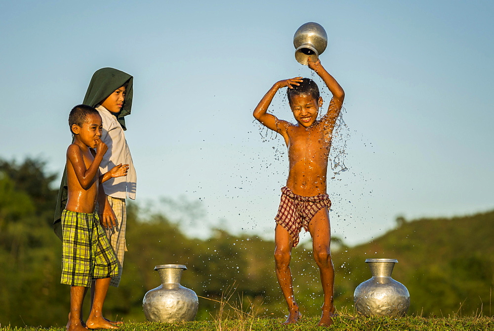 Boy washing himself, Mrauk U, Sittwe Division, Rakhine State, Myanmar, Asia