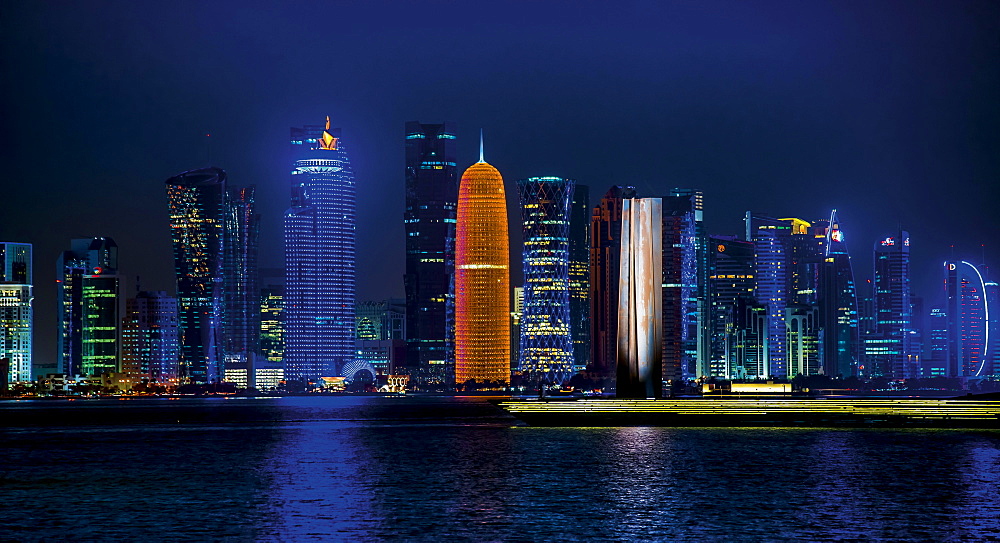 Night scene of the skyline of Doha with Al Bidda Tower, World Trade Center, Palm Tower 1 and 2, Burj Qatar Tower, Doha Corniche, Doha, Qatar, Asia