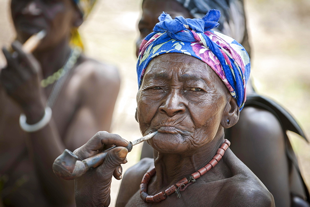 An elderly woman from the Koma people smoking a pipe, the animistic people live in the Alantika Mountains, Wangai, North Region, Cameroon, Africa