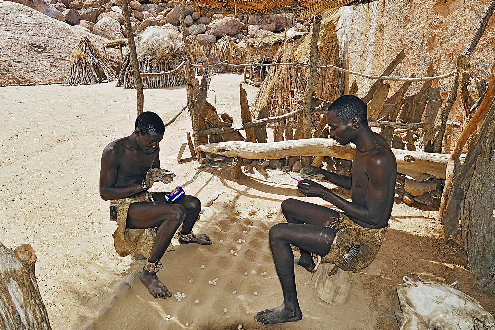 Two local men rolling cigarettes, Damara Living Museum, near Twyfelfontein, Namibia, Africa