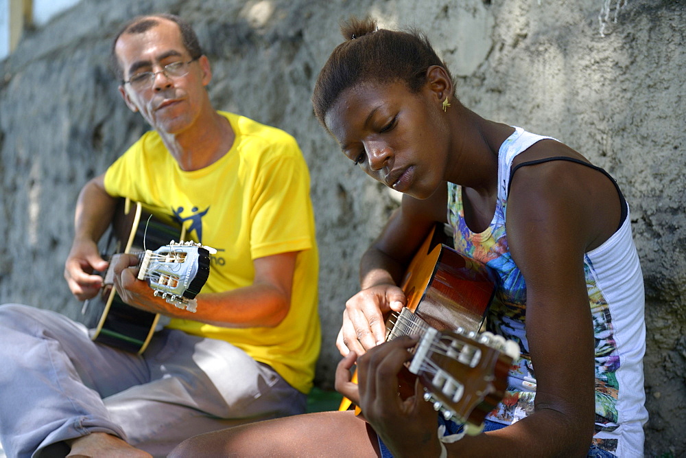 Street child, girl, 15, having guitar lessons with a social worker and musician, Sao Martinho social project, Lapa district, Rio de Janeiro, Rio de Janeiro State, Brazil, South America