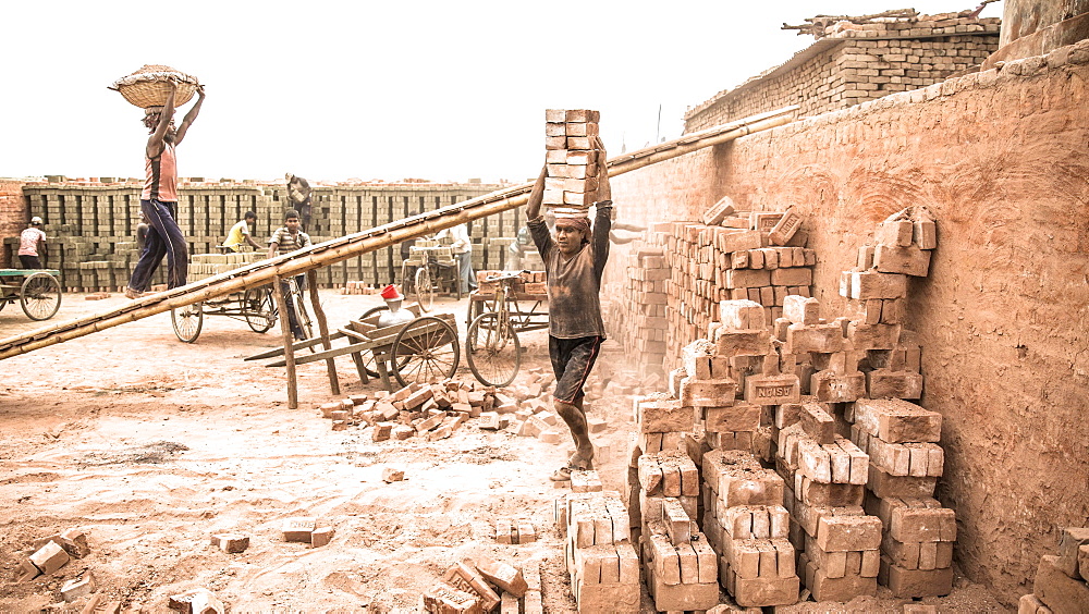 Workers with bricks on their heads in the brickyard, Dhaka, Bangladesh, Asia