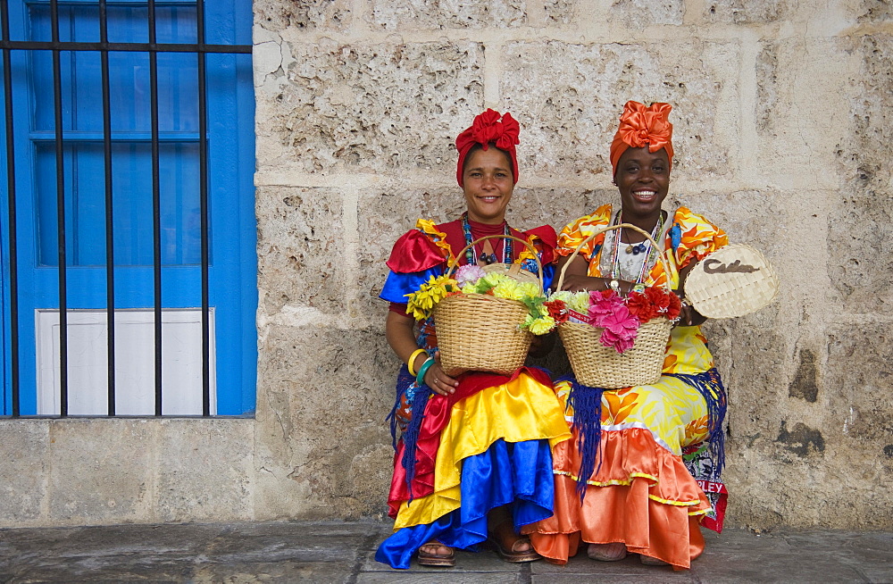 Two women wearing colourful dresses, Havana, Cuba, Central America