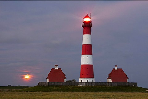 Westerhever lighthouse with the full moon rising above the horizon, Westerheversand, North Friesland district, Schleswig-Holstein, Germany, Europe