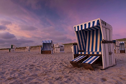 Roofed wicker beach chairs on the beach just after sunset, Hoernum, Sylt island, North Friesland district, Schleswig-Holstein, Germany, Europe