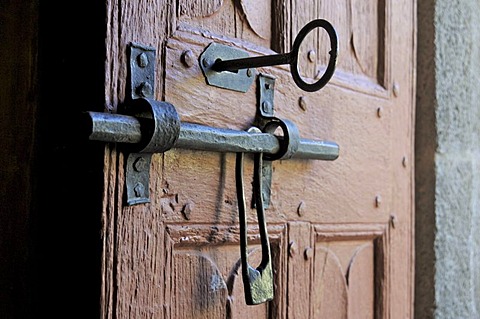 Old door of wood with its worn lock, Church in Cantal, Auvergne, France, Europe