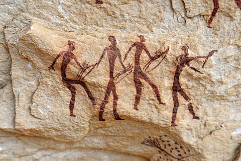 Group of painted warriors or hunters, neolithic rock art at Arakokem, Adrar Tekemberet, Immidir, Algeria, Sahara, North Africa