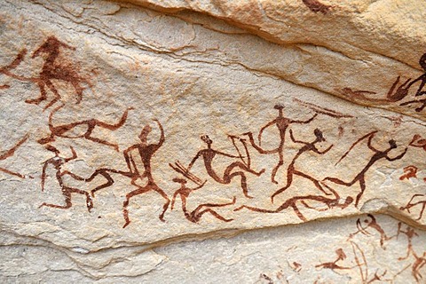 Group of painted warriors or hunters, neolithic rockart at Arakokem, Adrar Tekemberet, Immidir, Algeria, Sahara, North Africa