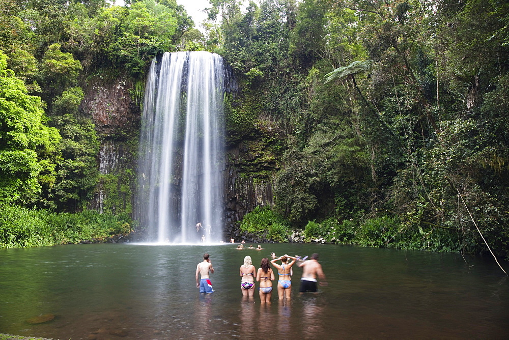 Young people bathing at Millaa Millaa Falls, Waterfall Circuit, Atherton Tablelands, Queensland, Australia