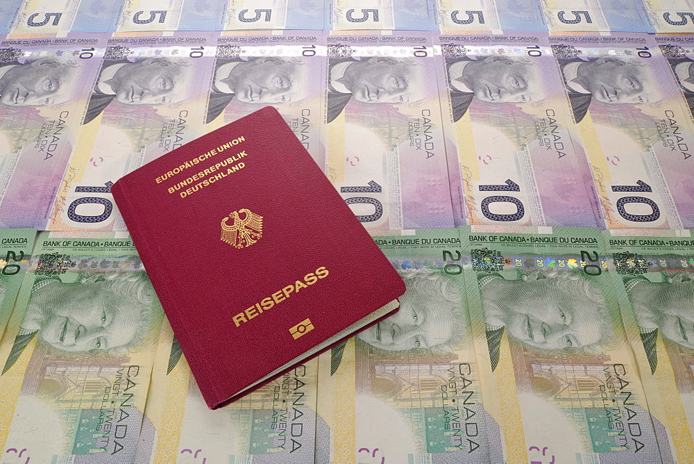 Passport of the Federal Republic of Germany and various Canadian dollar banknotes