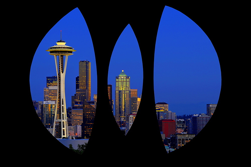 View through steel sculpture "Changing Form" by Doris Chase, Kerry Park, of the skyline of the Seattle financial district with Space Needle, full moon, Columbia Center, formerly Bank of America Tower, Municipal Tower, formerly Key Tower, US Bank Center, n