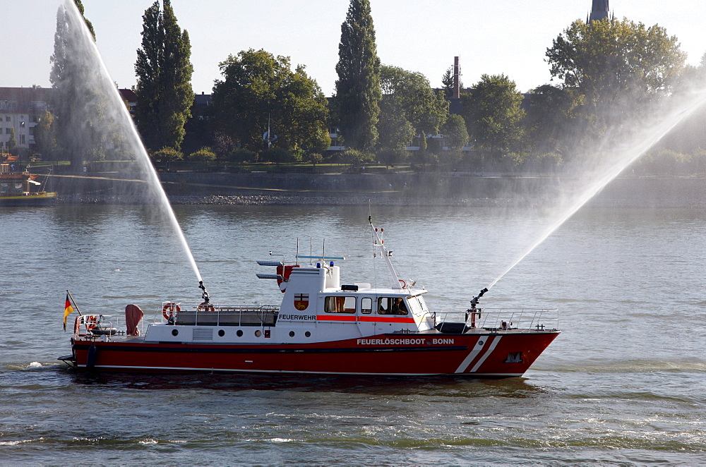 Fire fighting boat of the Bonn fire brigade on the Rhine with water jets from two cannon during a display, Bonn, North Rhine-Westphalia, Germany, Europe