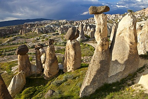 Tufa Fairy Chimneys with basalt blocks placed on top, rock formations at Cavushin, Goreme, UNESCO World Heritage Site, Cappadocia, Anatolia, Turkey