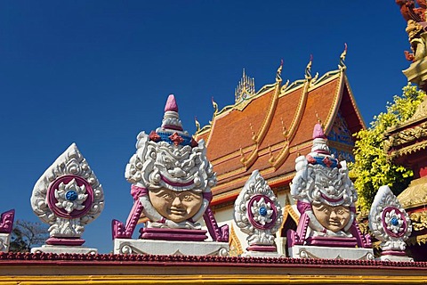 Reliefs of faces in the Buddhist temple at Dongpalan Road, Vientiane, Laos, Indochina, Asia