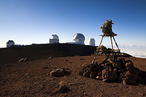 Hawaiian temple on the summit of the Mauna Kea Volcano, 4205m, part of the Mauna Kea Observatory on the horizon, Mauna Kea, Hawai'i, USA