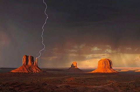 Lightning strikes during a thunderstorm in the evening light, composite, mesas with West Mitten Butte, East Mitten Butte, Merrick Butte, Monument Valley, Navajo Tribal Park, Navajo Nation Reservation, Arizona, Utah, United States of America, USA