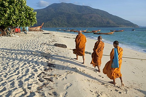 Monks collecting morning alms on the beach, island of Ko Lipe, Thailand, Asia