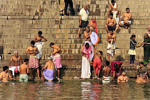Believers performing ritual purifications on the banks of the Ganges River in Varanasi, Benares, Uttar Pradesh, India, South Asia