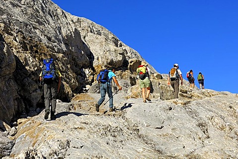 Hikers in a rocky passage on the way to the Cabane de Prarochet or Prarochet Huette alpine shelter, Valais, Switzerland, Europe