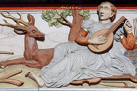 Musician playing a string instrument and a stag listening, sculptural decoration on the Zum breiten Herd building, historic district, Erfurt, Thuringia, Germany, Europe