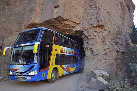 Coach driving through narrow tunnel, Tupiza, Departamento Potosi, Bolivia, South America