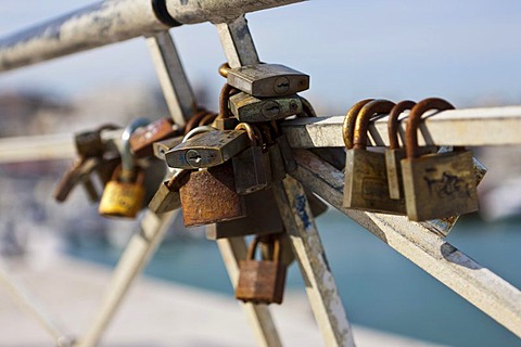 Old rusty padlocks on a railing