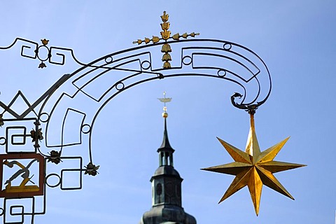 Golden star of "Hotel zum Goldenen Stern", tower of St. Mary's Church at back, c 1700, Marktplatz 6, Koenigsberg, Lower Franconia, Bavaria, Germany, Europe