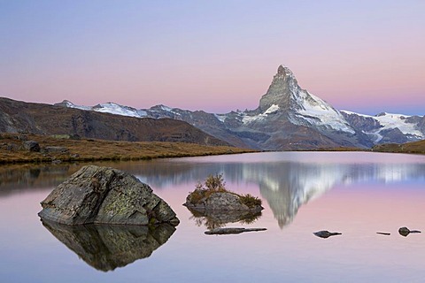 First morning light on Stellisee Lake overlooking Mt Matterhorn with reflections, Zermatt, Valais, Switzerland, Europe