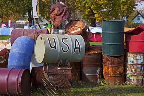 Old barrels, on of them labelled "USA", artwork at the Heidelberg Project, an outdoor public art project in a depressed neighborhood of Detroit created by artist Tyree Guyton, Michigan, USA