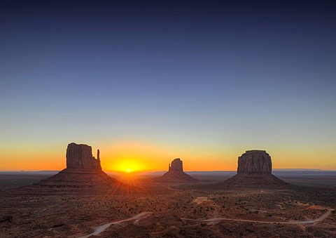 Sunrise, West Mitten Butte, East Mitten Butte and Merrick Butte table mountains and Scenic Drive, Monument Valley, Navajo Tribal Park, Navajo Nation Reservation, Arizona, Utah, United States of America