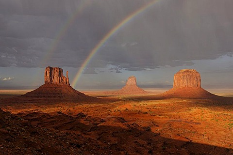 Double rainbow and rain in the evening light after a thunderstorm, West Mitten Butte, East Mitten Butte and Merrick Butte table mountains, Monument Valley, Navajo Tribal Park, Navajo Nation Reservation, Arizona, Utah, United States of America