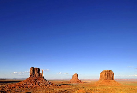 West Mitten Butte, East Mitten Butte and Merrick Butte table mountains and Scenic Drive in the evening light, Monument Valley, Navajo Tribal Park, Navajo Nation Reservation, Arizona, Utah, United States of America