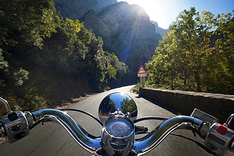 Motor scooter being driven in the Gorges de Galamus, a narrow passage between the departments Aude and Pyrenees-Orientales, Northern Catalonia, France, Europe, PublicGround