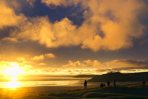 People on the beach watching the clouds, sunset, Atlantic Ocean, Finistere, Brittany, France, Europe