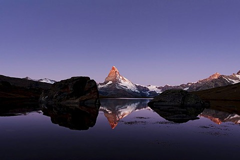 At first light, Mt Matterhorn is reflected in Stellisee Lake with visible umbra, Zermatt, Canton Valais, Switzerland, Europe, PublicGround