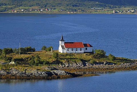 The lonely Sildpollnes Church, surrounded by water and high mountains on the Lofoten island of AustvÃ‚goy, Nordland, Norway, Europe