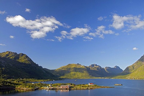 The tiny village of Sildpollnes and its church, surrounded by water and high mountains on the Lofoten island of AustvÃ‚goy, Nordland, Norway, Europe