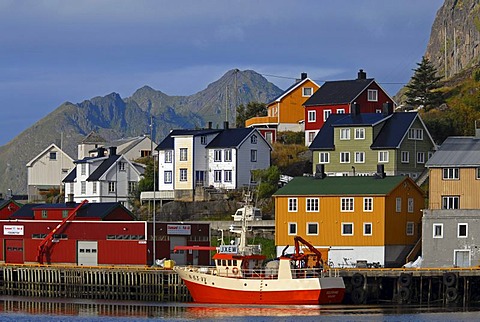 The boats and houses of Stamsund illuminated by warm morning light, Nordland, Norway, Europe