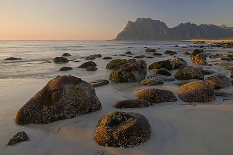 Boulders at Uttakleiv Beach illuminated by warm evening light, Nordland, Norway, Europe